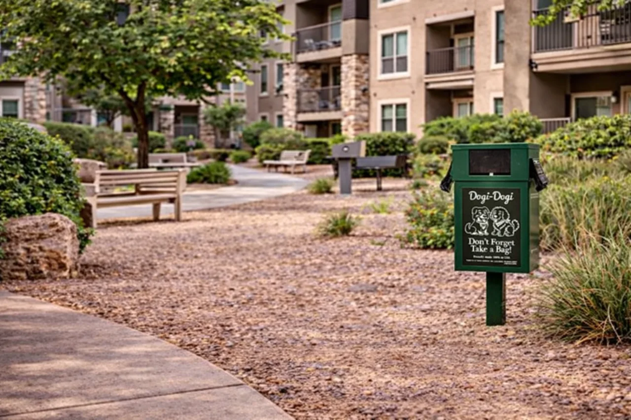 Pet waste station in a landscaped apartment or community setting